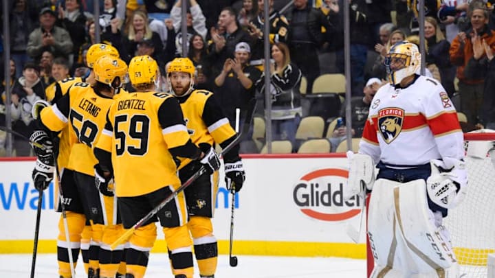 PITTSBURGH, PA - JANUARY 08: Pittsburgh Penguins Right Wing Bryan Rust (17) celebrates his goal with teammates as Florida Panthers Goalie Roberto Luongo (1) looks on during the first period in the NHL game between the Pittsburgh Penguins and the Florida Panthers on January 8, 2019, at PPG Paints Arena in Pittsburgh, PA. (Photo by Jeanine Leech/Icon Sportswire via Getty Images)