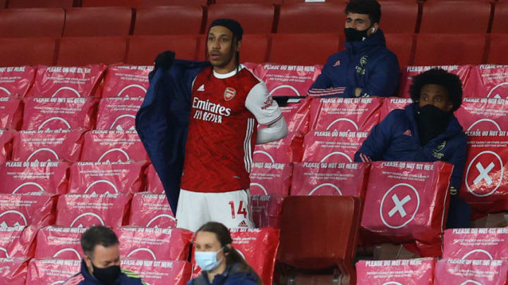 LONDON, ENGLAND - APRIL 03: Pierre-Emerick Aubameyang of Arsenal looks on from the substitutes bench as he puts a jacket on after being substituted off during the Premier League match between Arsenal and Liverpool at Emirates Stadium on April 03, 2021 in London, England. Sporting stadiums around the UK remain under strict restrictions due to the Coronavirus Pandemic as Government social distancing laws prohibit fans inside venues resulting in games being played behind closed doors. (Photo by Julian Finney/Getty Images)
