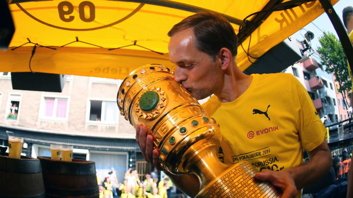 Dortmund’s head coach Thomas Tuchel kisses the trophy as they arrive at Borsigplatz during celebrations after winning the German Cup final (DFB Pokalfinale) in Dortmund, western Germany, on May 28, 2017. / AFP PHOTO / POOL / Ina FASSBENDER (Photo credit should read INA FASSBENDER/AFP/Getty Images)