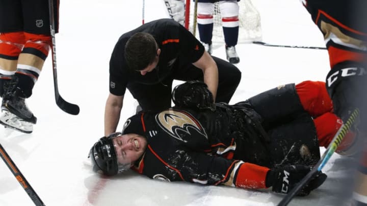 ANAHEIM, CA - DECEMBER 6: Nick Ritchie #37 of the Anaheim Ducks gets attention from Ducks head athletic trainer, Joe Huff after a hit during the game against the Washington Capitals at Honda Center on December 6, 2019 in Anaheim, California. (Photo by Debora Robinson/NHLI via Getty Images)