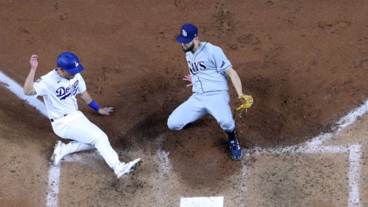 ARLINGTON, TEXAS - OCTOBER 27: Austin Barnes #15 of the Los Angeles Dodgers slides in safely past Nick Anderson #70 of the Tampa Bay Rays to score a run on a wild pitch during the sixth inning in Game Six of the 2020 MLB World Series at Globe Life Field on October 27, 2020 in Arlington, Texas. (Photo by Tom Pennington/Getty Images)