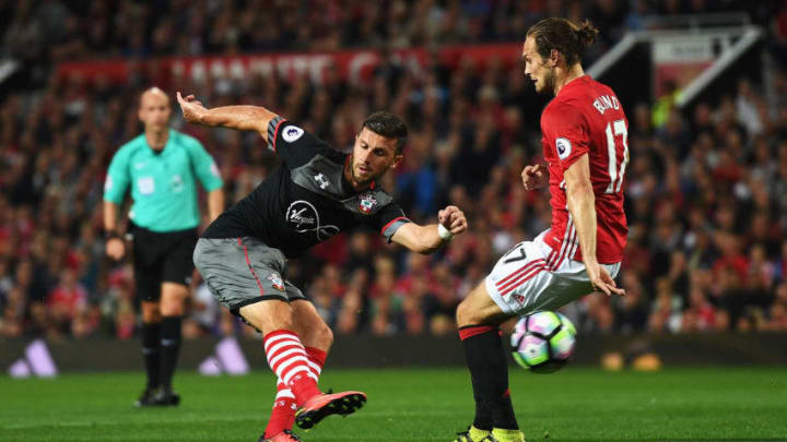 MANCHESTER, ENGLAND - AUGUST 19: Shane Long of Southampton takes on Daley Blind of Manchester United during the Premier League match between Manchester United and Southampton at Old Trafford on August 19, 2016 in Manchester, England. (Photo by Michael Regan/Getty Images)