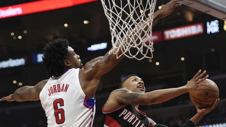 Mar 24, 2016; Los Angeles, CA, USA; Portland Trail Blazers guard Damian Lillard (0) attempts a shot defended by Los Angeles Clippers center DeAndre Jordan (6) during the first half at Staples Center. Mandatory Credit: Kelvin Kuo-USA TODAY Sports