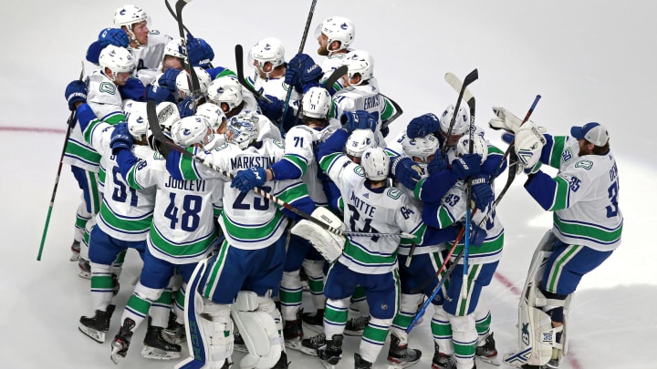 The Vancouver Canucks celebrate their 5-4 win on a goal by Christopher Tanev #8 (Photo by Jeff Vinnick/Getty Images)