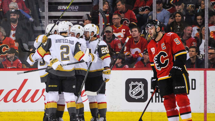 CALGARY, AB – MARCH 8: Nick Holden #22 (C) of the Vegas Golden Knights celebrates with his teammates after scoring against the Calgary Flames during an NHL game at Scotiabank Saddledome on March 8, 2020 in Calgary, Alberta, Canada. (Photo by Derek Leung/Getty Images)