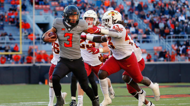 STILLWATER, OK – OCTOBER 24: Quarterback Spencer Sanders #3 of the Oklahoma State Cowboys stiff arms linebacker Dae’Shawn Davis #43 of the Iowa State Cylcones on his way to a 21-yard touchdown called back for a holding penalty in the fourth quarter at Boone Pickens Stadium on October 24, 2020 in Stillwater, Oklahoma. OSU won 24-21. (Photo by Brian Bahr/Getty Images)