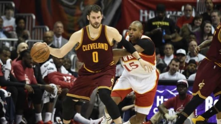 Mar 6, 2015; Atlanta, GA, USA; Cleveland Cavaliers forward Kevin Love (0) dribbles in front of Atlanta Hawks center Al Horford (15) during the second half at Philips Arena. The Hawks defeated the Cavaliers 106-97. Mandatory Credit: Dale Zanine-USA TODAY Sports