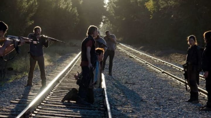 The Saviors and Alexandrians on the train tracks - The Walking Dead, AMC