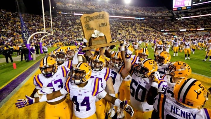 Oct 22, 2016; Baton Rouge, LA, USA; LSU Tigers players celebrate with the Magnolia Bowl trophy following a win against the Mississippi Rebels in a game at Tiger Stadium. LSU defeated Mississippi 38-21. Mandatory Credit: Derick E. Hingle-USA TODAY Sports