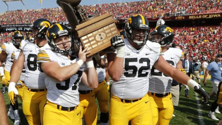 AMES, IA - SEPTEMBER 9: Defensive back Brandon Snyder #37 of the Iowa Hawkeyes, and offensive lineman Boone Myers #52 of the Iowa Hawkeyes celebrate by carrying the Cy-Hawk Trophy to their fans after defeating the Iowa State Cyclones 44-41 in overtime at Jack Trice Stadium on September 9, 2017 in Ames, Iowa. The Iowa Hawkeyes won 44-41 over the Iowa State Cyclones. (Photo by David Purdy/Getty Images)