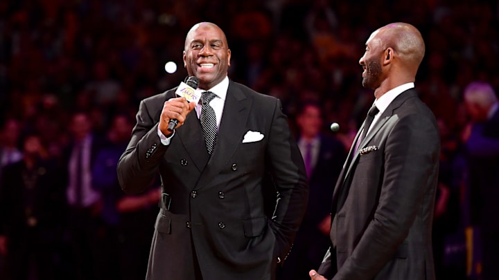 LOS ANGELES, CA – DECEMBER 18: (L-R) Earvin ‘Magic’ Johnson addresses the crowd before Kobe Bryant has his