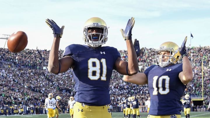 SOUTH BEND, IN - OCTOBER 13: Miles Boykin #81 of the Notre Dame Fighting Irish reacts with Chris Finke #10 after scoring the touchdown to take the lead against the Pittsburgh Panthers in the second half at Notre Dame Stadium on October 13, 2018 in South Bend, Indiana. (Photo by Quinn Harris/Getty Images)