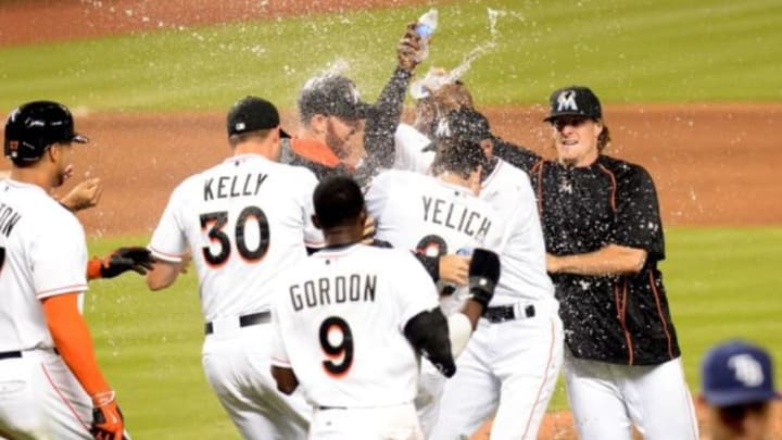 Apr 10, 2015; Miami, FL, USA; Miami Marlins left fielder Christian Yelich (center) celebrates with teammates after hitting the game winning run in during the 10th inning against the Tampa Bay Rays at Marlins Park. The Marlins won 10-9. Mandatory Credit: Steve Mitchell-USA TODAY Sports