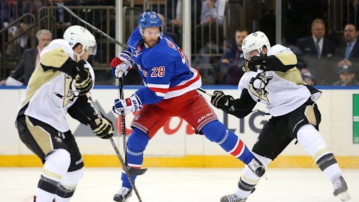 Apr 19, 2016; New York, NY, USA; New York Rangers center Dominic Moore (28) plays the puck between Pittsburgh Penguins left wing Chris Kunitz (14) and defenseman Ian Cole (28) during the second period of game three of the first round of the 2016 Stanley Cup Playoffs at Madison Square Garden. Mandatory Credit: Brad Penner-USA TODAY Sports