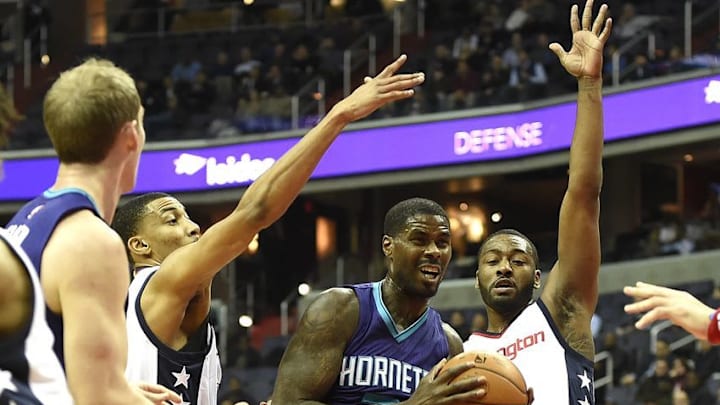 Dec 14, 2016; Washington, DC, USA; Charlotte Hornets guard Nicolas Batum (5) makes a move to the basket in between Washington Wizards forward Otto Porter Jr. (22) and guard John Wall (2) during the first quarter at Verizon Center. Mandatory Credit: