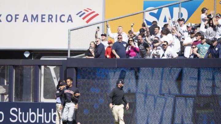 Apr 23, 2022; Bronx, New York, USA; Cleveland Guardians center fielder Oscar Mercado (35) is walked away from the outfield stands after fans throw beer and water bottles at him after the ninth inning against the New York Yankees at Yankee Stadium. Mandatory Credit: Gregory Fisher-USA TODAY Sports