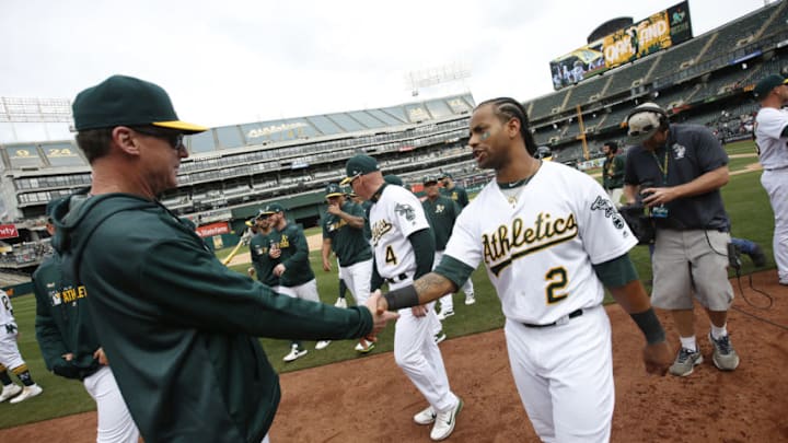 OAKLAND, CA - APRIL 4: Manager Bob Melvin #6 and Khris Davis #2 of the Oakland Athletics celebrate on the field following the game against the Boston Red Sox at the Oakland-Alameda County Coliseum on April 4, 2019 in Oakland, California. The Athletics defeated the Red Sox 7-3. (Photo by Michael Zagaris/Oakland Athletics/Getty Images)