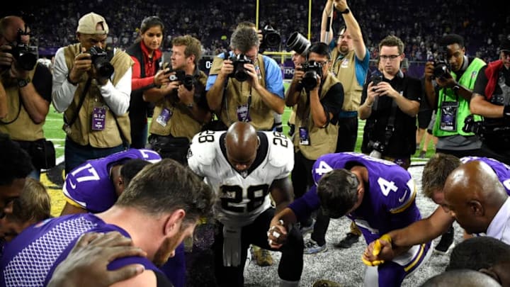 MINNEAPOLIS, MN - SEPTEMBER 11: Adrian Peterson #28 of the New Orleans Saints and members of the Minnesota Vikings meet mid field after the game on September 11, 2017 at U.S. Bank Stadium in Minneapolis, Minnesota. The Vikings defeated the Saints 29-19 in Peterson's return to Minnesota. (Photo by Hannah Foslien/Getty Images)