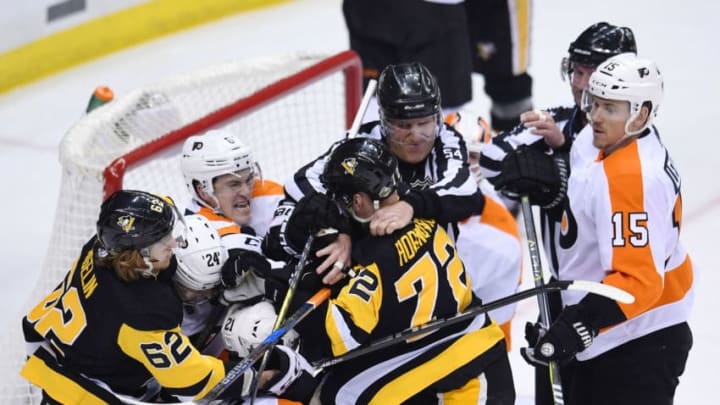 PITTSBURGH, PA - APRIL 13: Pittsburgh Penguins right wing Patric Hornqvist (72) and Pittsburgh Penguins left wing Carl Hagelin (62) scrum with Philadelphia Flyers defenseman Travis Sanheim (6), Philadelphia Flyers right wing Matt Read (24) and Philadelphia Flyers center Scott Laughton (21) during the second period. The Philadelphia Flyers won 5-1 in Game Two of the Eastern Conference First Round during the 2018 NHL Stanley Cup Playoffs against the Pittsburgh Penguins on April 13, 2018, at PPG Paints Arena in Pittsburgh, PA. (Photo by Jeanine Leech/Icon Sportswire via Getty Images)