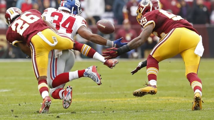 Nov 29, 2015; Landover, MD, USA; Washington Redskins inside linebacker Perry Riley (56) intercepts a pass intended for New York Giants running back Shane Vereen (34) as Redskins cornerback Bashaud Breeland (26) defends in the first quarter at FedEx Field. Mandatory Credit: Geoff Burke-USA TODAY Sports
