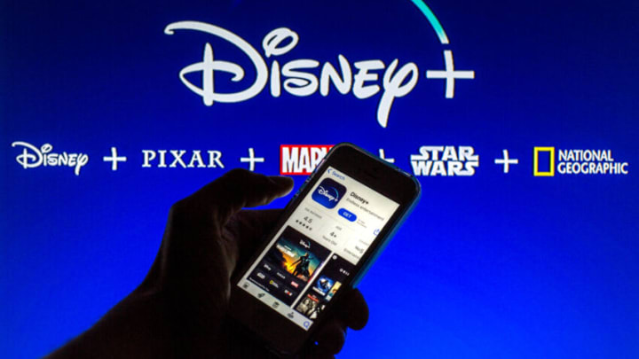 SPAIN - 2021/03/23: In this photo illustration the Disney+ App seen displayed on a smartphone screen in App Store with the Disney+ logo in the background. (Photo Illustration by Thiago Prudêncio/SOPA Images/LightRocket via Getty Images)