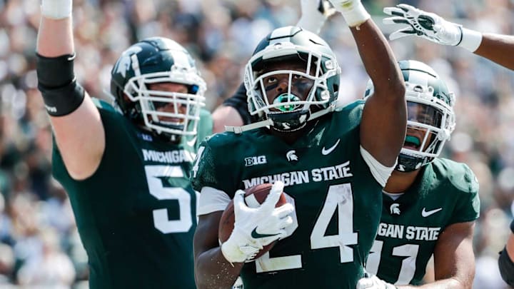 Michigan State running back Elijah Collins (24) celebrates a touchdown against Youngstown State during the first half at Spartan Stadium in East Lansing on Saturday, Sept. 11, 2021.