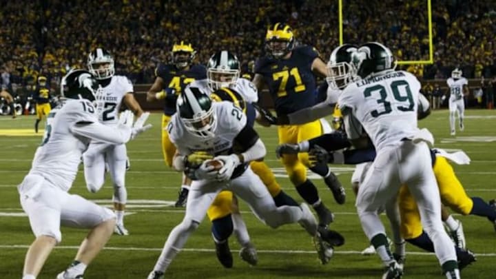 Oct 17, 2015; Ann Arbor, MI, USA; Michigan State Spartans defensive back Jalen Watts-Jackson (20) dives into the end zone for a game winning touchdown as the clock runs out in the fourth quarter against the Michigan Wolverines at Michigan Stadium. Michigan State 27-23. Mandatory Credit: Rick Osentoski-USA TODAY Sports Oct 17, 2015; Ann Arbor, MI, USA; Michigan State Spartans defensive back Jalen Watts-Jackson (20) dives into the end zone for a game winning touchdown as the clock runs out in the fourth quarter against the Michigan Wolverines at Michigan Stadium. Michigan State 27-23. Mandatory Credit: Rick Osentoski-USA TODAY Sports