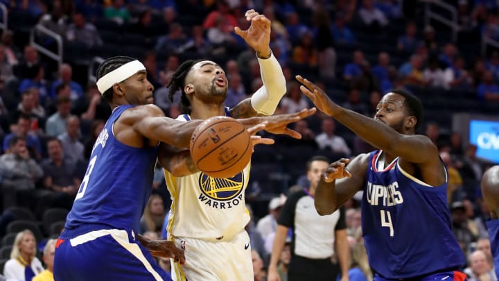 SAN FRANCISCO, CALIFORNIA – OCTOBER 24: D’Angelo Russell #0 of the Golden State Warriors tries to drive between Maurice Harkless #8 and JaMychal Green #4 of the LA Clippers at Chase Center on October 24, 2019, in San Francisco, California. (Photo by Ezra Shaw/Getty Images)