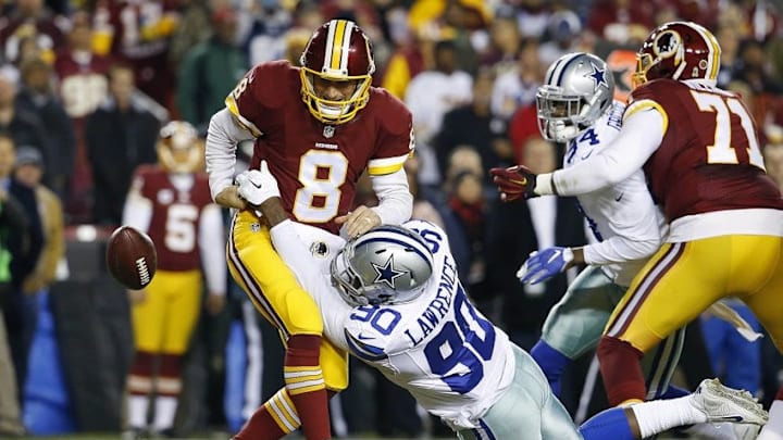 Dec 7, 2015; Landover, MD, USA; Washington Redskins quarterback Kirk Cousins (8) fumbles the ball after being hit by Dallas Cowboys defensive end Demarcus Lawrence (90) in the first quarter at FedEx Field. Mandatory Credit: Geoff Burke-USA TODAY Sports