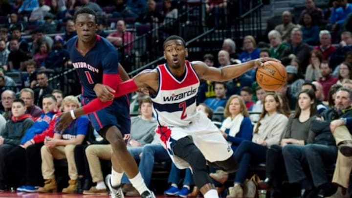 Feb 22, 2015; Auburn Hills, MI, USA; Washington Wizards guard John Wall (2) drives to the basket against Detroit Pistons guard Reggie Jackson (1) during the second quarter at The Palace of Auburn Hills. Mandatory Credit: Tim Fuller-USA TODAY Sports