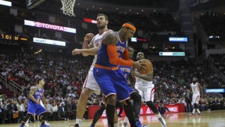 Nov 24, 2014; Houston, TX, USA; New York Knicks forward Carmelo Anthony (7) gets a rebound from Houston Rockets forward Donatas Motiejunas (20) during the second quarter at Toyota Center. Mandatory Credit: Troy Taormina-USA TODAY Sports