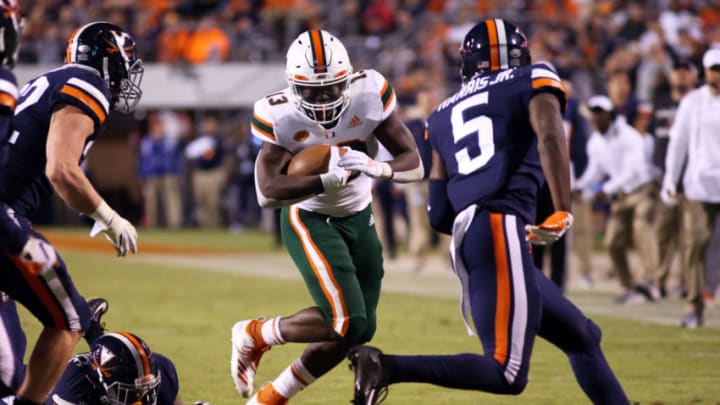 CHARLOTTESVILLE, VA - OCTOBER 13: DeeJay Dallas #13 of the Miami Hurricanes rushes in the first half during a game against the Virginia Cavaliers at Scott Stadium on October 13, 2018 in Charlottesville, Virginia. (Photo by Ryan M. Kelly/Getty Images)