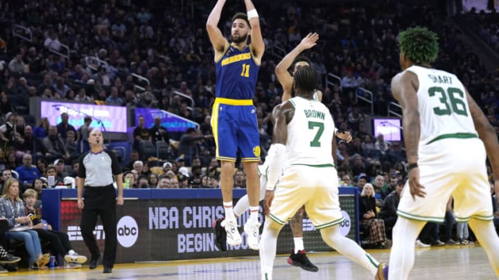SAN FRANCISCO, CALIFORNIA - DECEMBER 10: Klay Thompson #11 of the Golden State Warriors shoots and scores over Jaylen Brown #7 and Jayson Tatum #0 of the Boston Celtics during the second quarter of an NBA basketball game at Chase Center on December 10, 2022 in San Francisco, California. NOTE TO USER: User expressly acknowledges and agrees that, by downloading and or using this photograph, User is consenting to the terms and conditions of the Getty Images License Agreement. (Photo by Thearon W. Henderson/Getty Images)