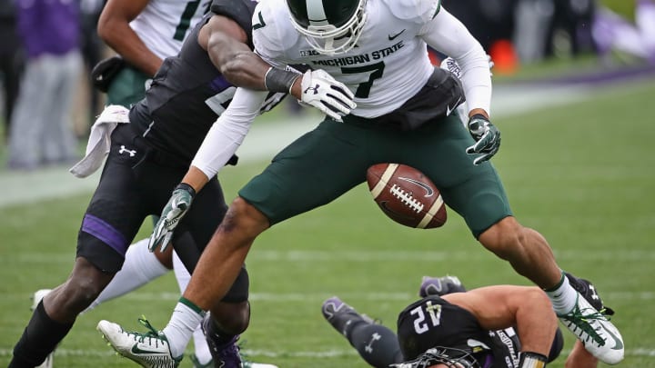 EVANSTON, IL – OCTOBER 28: Cody White #7 of the Michigan State Spartans fumbles the ball as he’s hit by Montre Hartage #24 of the Northwestern Wildcats at Ryan Field on October 28, 2017 in Evanston, Illinois. (Photo by Jonathan Daniel/Getty Images)