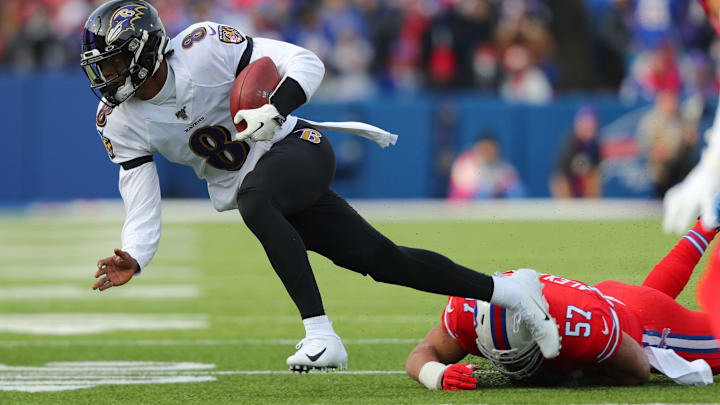 ORCHARD PARK, NY – DECEMBER 8: Lorenzo Alexander #57 of the Buffalo Bills dives to make a tackle on Lamar Jackson #8 of the Baltimore Ravens as he runs the ball during the first quarter at New Era Field on December 8, 2019 in Orchard Park, New York. (Photo by Timothy T Ludwig/Getty Images)