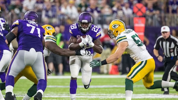 Sep 18, 2016; Minneapolis, MN, USA; Minnesota Vikings running back Adrian Peterson (28) carries the ball and is injured on the play during the third quarter against the Green Bay Packers at U.S. Bank Stadium. The Vikings defeated the Packers 17-14. Mandatory Credit: Brace Hemmelgarn-USA TODAY Sports