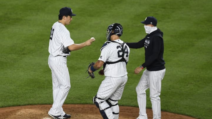 NEW YORK, NEW YORK - AUGUST 18: Masahiro Tanaka #19 of the New York Yankees is taken off the mound during the fifth inning against the Tampa Bay Rays at Yankee Stadium on August 18, 2020 in the Bronx borough of New York City. (Photo by Sarah Stier/Getty Images)