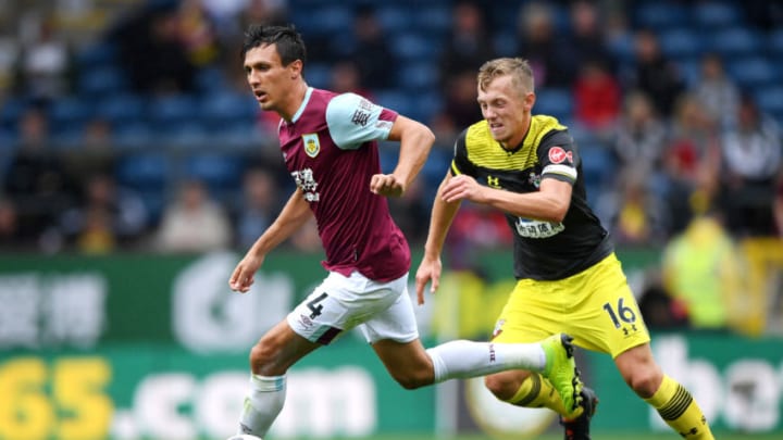BURNLEY, ENGLAND – AUGUST 10: Jack Cork of Burnley runs with the ball under pressure from James Ward-Prowse of Southampton during the Premier League match between Burnley FC and Southampton FC at Turf Moor on August 10, 2019 in Burnley, United Kingdom. (Photo by Stu Forster/Getty Images)