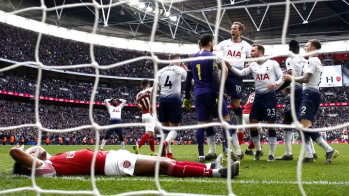 LONDON, ENGLAND - MARCH 02: Hugo Lloris of Tottenham Hotspur celebrates with teammates after saving a penalty whilst Pierre-Emerick Aubameyang of Arsenal looks dejected during the Premier League match between Tottenham Hotspur and Arsenal FC at Wembley Stadium on March 02, 2019 in London, United Kingdom. (Photo by Julian Finney/Getty Images)