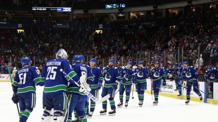 VANCOUVER, BC - DECEMBER 21: Jacob Markstrom #25 of the Vancouver Canucks is congratulated by teammates after their win against the Pittsburgh Penguins at Rogers Arena December 21, 2019 in Vancouver, British Columbia, Canada. Vancouver won 4-1. (Photo by Jeff Vinnick/NHLI via Getty Images)