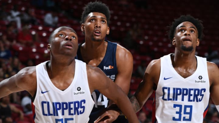 LAS VEGAS, NV - JULY 7: Mfiondu Kabengele #25 of the LA Clippers and Doral Moore #14 of the Memphis Grizzlies fights for position to grab the rebound during Day 3 of the 2019 Las Vegas Summer League on July 7, 2019 at the Thomas & Mack Center in Las Vegas, Nevada. NOTE TO USER: User expressly acknowledges and agrees that, by downloading and/or using this Photograph, user is consenting to the terms and conditions of the Getty Images License Agreement. Mandatory Copyright Notice: Copyright 2019 NBAE (Photo by Garrett Ellwood/NBAE via Getty Images)