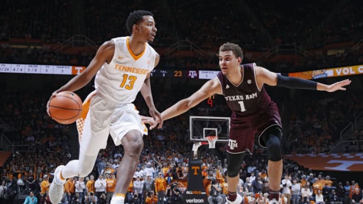 KNOXVILLE, TN - JANUARY 13: Jalen Johnson #13 of the Tennessee Volunteers drives against DJ Hogg #1 of the Texas A&M Aggies in the first half of a game at Thompson-Boling Arena on January 13, 2018 in Knoxville, Tennessee. (Photo by Joe Robbins/Getty Images)