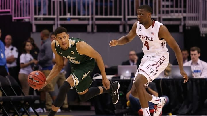 Mar 11, 2016; Orlando, FL, USA; South Florida Bulls forward Angel Nunez (22) dribbles the ball as Temple Owls guard Daniel Dingle (4) defends in the first half during the AAC Tournament at the Amway Center. Mandatory Credit: Logan Bowles-USA TODAY Sports