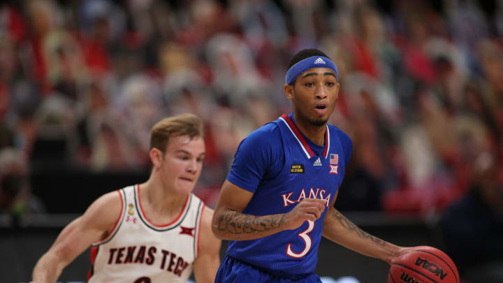 Dec 17, 2020; Lubbock, Texas, USA; Kansas Jayhawks guard Dajuan Harris Jr. (3) works the ball against Texas Tech Red Raiders guard Mac McClung (0) in the second half at United Supermarkets Arena. Mandatory Credit: Michael C. Johnson-USA TODAY Sports