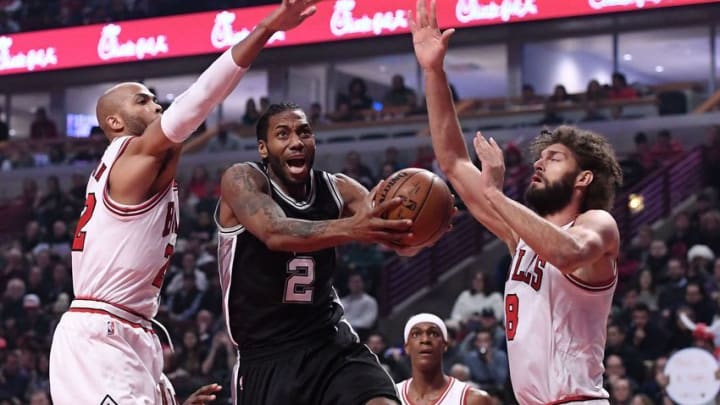 Dec 8, 2016; Chicago, IL, USA; San Antonio Spurs forward Kawhi Leonard (2) shoots the ball against Chicago Bulls forward Taj Gibson (22) and center Robin Lopez (8) during the first half at the United Center. Mandatory Credit: Mike DiNovo-USA TODAY Sports