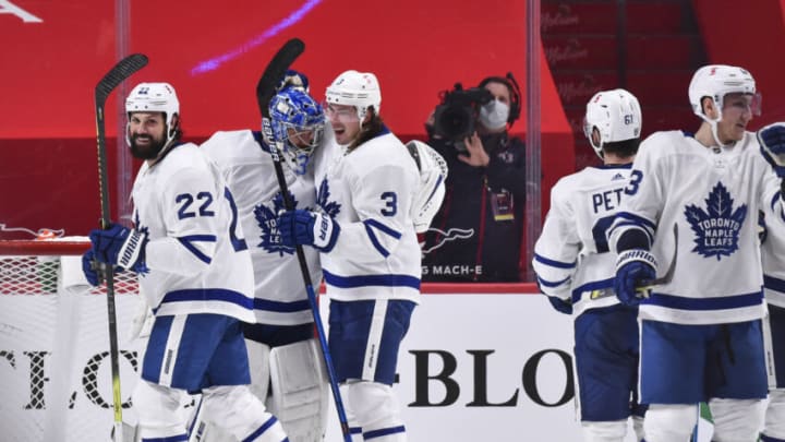 MONTREAL, QC - FEBRUARY 10: Zach Bogosian #22 and Justin Holl #3 of the Toronto Maple Leafs celebrate a 4-2 win with goalie Frederik Andersen #31 over the Montreal Canadiens at the Bell Centre on February 10, 2021 in Montreal, Canada. (Photo by Minas Panagiotakis/Getty Images)