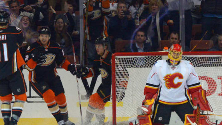 Mar 30, 2016; Anaheim, CA, USA; Calgary Flames goalie Jonas Hiller (1) reacts in goal as center Brandon Pirri (11), Anaheim Ducks center Shawn Horcoff (22) and defenseman Cam Fowler (4) celebrate a goal in the first period of the game at Honda Center. Mandatory Credit: Jayne Kamin-Oncea-USA TODAY Sports