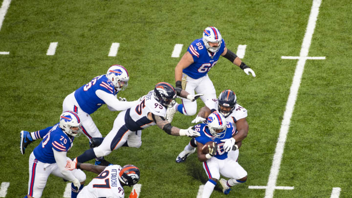 ORCHARD PARK, NY – NOVEMBER 24: Derek Wolfe #95 and Shelby Harris #96 of the Denver Broncos tackle Devin Singletary #26 of the Buffalo Bills during the first quarter at New Era Field on November 24, 2019 in Orchard Park, New York. Buffalo defeats Denver 20-3. (Photo by Brett Carlsen/Getty Images)