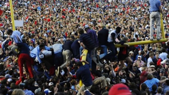 Oct 4, 2014; Oxford, MS, USA; Mississippi Rebels fans hang from the goal posts after a win against the Alabama Crimson Tide at Vaught-Hemingway Stadium. The Rebels won 23-17. Mandatory Credit: Christopher Hanewinckel-USA TODAY Sports
