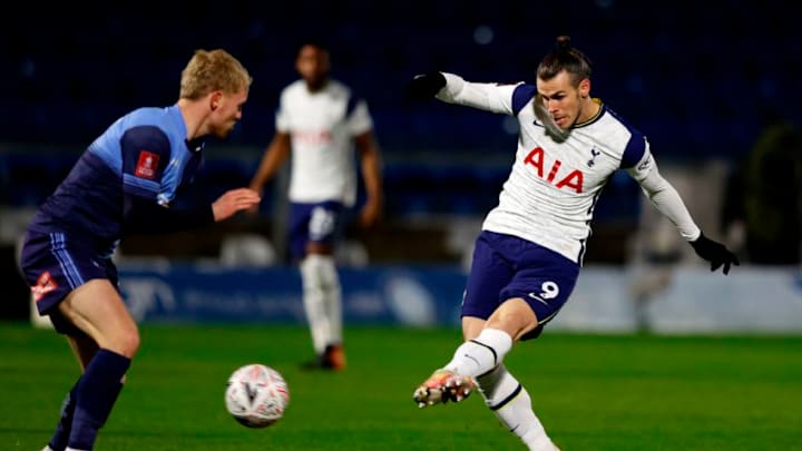 Tottenham Hotspur's Welsh striker Gareth Bale (R) has an unsuccessful shot during the English FA Cup fourth round football match between Wycombe Wanderers and Tottenham Hotspur at Adams Park Stadium in High Wycombe, west of London on January 25, 2021. (Photo by Adrian DENNIS / AFP) / RESTRICTED TO EDITORIAL USE. No use with unauthorized audio, video, data, fixture lists, club/league logos or 'live' services. Online in-match use limited to 120 images. An additional 40 images may be used in extra time. No video emulation. Social media in-match use limited to 120 images. An additional 40 images may be used in extra time. No use in betting publications, games or single club/league/player publications. / (Photo by ADRIAN DENNIS/AFP via Getty Images)